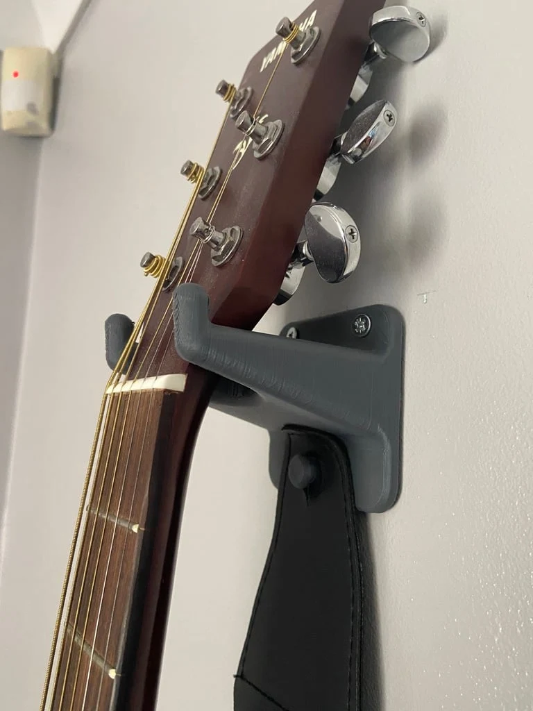 Support mural pour guitare avec espace pour médiators et sangle